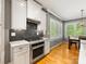 This kitchen features stainless steel appliances, granite countertops, white cabinets and recessed lighting at 7409 Tarland Ln, Charlotte, NC 28269