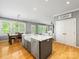 The kitchen island features a large sink and seating, creating an inviting space for entertaining at 7409 Tarland Ln, Charlotte, NC 28269