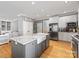 This kitchen island offers seating, a sink, and a view into the living room at 7409 Tarland Ln, Charlotte, NC 28269