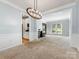 Bright, open-concept living room featuring recessed lighting, wainscoting, and views to the kitchen at 7409 Tarland Ln, Charlotte, NC 28269
