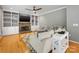 Bright living room with hardwood floors, fireplace, ceiling fan and custom built-in shelving at 7409 Tarland Ln, Charlotte, NC 28269