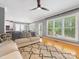 Living room featuring hardwood floors, modern decor, and natural light from the large windows at 7409 Tarland Ln, Charlotte, NC 28269