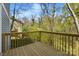 View of the back deck showing the wood flooring and railing overlooking a wooded area at 76 Snyder Ne Ct, Concord, NC 28025