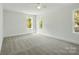 Bedroom with neutral carpet, white walls, a ceiling fan, and bright windows at 76 Snyder Ne Ct, Concord, NC 28025