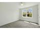Bedroom with neutral carpet, white walls, and a large window at 76 Snyder Ne Ct, Concord, NC 28025