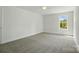 Bright bedroom with neutral carpet and a window with wooded view at 76 Snyder Ne Ct, Concord, NC 28025