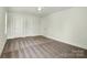 Bedroom with neutral carpet, two closet doors, and a window at 76 Snyder Ne Ct, Concord, NC 28025