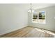 Dining room with wood-look vinyl flooring and a bright window at 76 Snyder Ne Ct, Concord, NC 28025