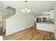 Open living room featuring wood flooring and white walls leading to a kitchen with stainless steel appliances at 76 Snyder Ne Ct, Concord, NC 28025