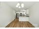 Bright living room and kitchen area with modern appliances and wood-look vinyl flooring at 76 Snyder Ne Ct, Concord, NC 28025