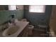 Retro bathroom featuring green tiles, a window, and shower seat at 828 Williams St, Gastonia, NC 28052