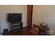Bedroom featuring neutral walls, wood flooring, and a television on an entertainment stand at 828 Williams St, Gastonia, NC 28052