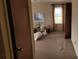 Living room with neutral walls, carpet flooring, bright window, and storage boxes at 828 Williams St, Gastonia, NC 28052