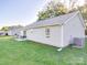 Well-maintained backyard with green grass, a patio area, and vinyl siding on the home's exterior at 833 Generation Ln, Clover, SC 29710