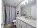 Bathroom with white cabinets, granite countertops, and gray shower curtain at 833 Generation Ln, Clover, SC 29710