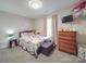 Charming bedroom featuring a colorful bedspread, wooden dresser, and ample natural light at 833 Generation Ln, Clover, SC 29710