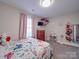 Cozy bedroom with gray carpet, pink curtains, dresser, and toys at 833 Generation Ln, Clover, SC 29710