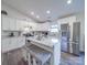 Bright kitchen features a granite island with seating, stainless steel appliances, and white cabinetry at 833 Generation Ln, Clover, SC 29710