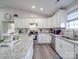 This renovated kitchen has granite countertops, stainless appliances, and white cabinetry creating a modern look at 833 Generation Ln, Clover, SC 29710