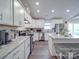 Modern kitchen featuring white cabinetry, stainless steel appliances, and granite countertops on a large island at 833 Generation Ln, Clover, SC 29710