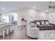 Bright living room and dining area boasts an open layout with modern finishes and hardwood floors at 833 Generation Ln, Clover, SC 29710