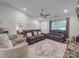 Open living room with comfortable seating, a ceiling fan, and a view into the bedroom and front door at 833 Generation Ln, Clover, SC 29710