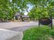 View of the gated entrance to The Club at Longview featuring a stone guardhouse and elegant signage at 8710 Chewton Glen Dr, Waxhaw, NC 28173