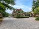 Wrought iron gate welcomes residents to a private community, secured by stone pillars and manicured greenery at 8710 Chewton Glen Dr, Waxhaw, NC 28173