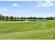 Picturesque golf course with a serene pond and fountain, surrounded by meticulously maintained green landscape at 8710 Chewton Glen Dr, Waxhaw, NC 28173