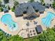 A captivating aerial view of a community pool with dual pools, a hot tub, and ample seating at 8710 Chewton Glen Dr, Waxhaw, NC 28173