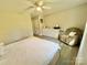 Bright bedroom featuring a ceiling fan, closet, dresser, and comfortable beige armchair at 903 Lakeview St, Kannapolis, NC 28083