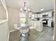 Bright dining area featuring a glass table, white chairs, and modern lighting fixtures at 903 Lakeview St, Kannapolis, NC 28083