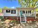 Charming one-story home featuring a cozy front porch with a vibrant blue door and a well-manicured lawn at 903 Lakeview St, Kannapolis, NC 28083