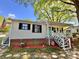A cozy home with a delightful porch, complete with an American flag and attractive brick accents at 903 Lakeview St, Kannapolis, NC 28083