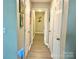 Hallway with artwork on the walls and multiple doors leading to different rooms at 903 Lakeview St, Kannapolis, NC 28083