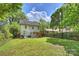 The property features a lush backyard with a patio, modern pergola and mature trees at 908 Academy St, Charlotte, NC 28205