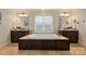 Open and bright bathroom with jacuzzi tub, dual mirrors, and granite counters at 908 Academy St, Charlotte, NC 28205