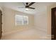 Bright bedroom featuring neutral walls, carpet, and a ceiling fan at 908 Academy St, Charlotte, NC 28205