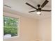 Cozy bedroom with ceiling fan and a view of the green outdoors at 908 Academy St, Charlotte, NC 28205