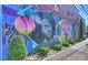 Eye-catching brick wall mural featuring colorful artwork and portraits enhances the building's exterior at 908 Academy St, Charlotte, NC 28205