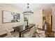 Elegant dining room features modern light fixture, stylish rug, and hardwood floors at 908 Academy St, Charlotte, NC 28205