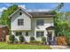 Charming two-story home featuring a landscaped front yard with well-manicured bushes and a covered front porch at 908 Academy St, Charlotte, NC 28205