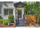 Inviting front porch with dark wood steps and a well-manicured bush at 908 Academy St, Charlotte, NC 28205