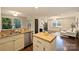 Open concept kitchen with stainless steel appliances, granite countertops, and adjacent living room at 908 Academy St, Charlotte, NC 28205