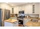 Kitchen with stainless steel appliances, granite countertops, and center island with wooden top at 908 Academy St, Charlotte, NC 28205
