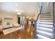 Bright living room with hardwood floors, open to the kitchen, and staircase at 908 Academy St, Charlotte, NC 28205