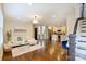Bright living room with hardwood floors, open to the kitchen, and staircase at 908 Academy St, Charlotte, NC 28205