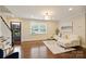 Bright living room featuring hardwood floors and a large window at 908 Academy St, Charlotte, NC 28205