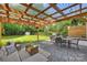 Outdoor patio area featuring a modern pergola, seating area and a gas grill at 908 Academy St, Charlotte, NC 28205
