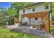 Back patio featuring a modern pergola, outdoor seating area, a gas grill, and a lush green lawn at 908 Academy St, Charlotte, NC 28205